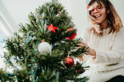 Woman with christmas tree in winter