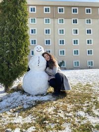 Young woman with snowman 