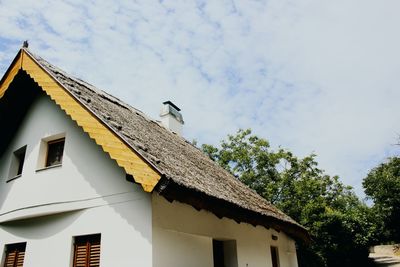 Low angle view of birds perching on roof of building