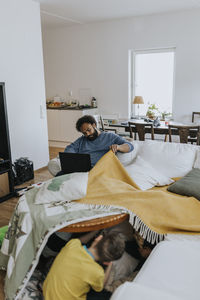 Man working from home and taking care of children