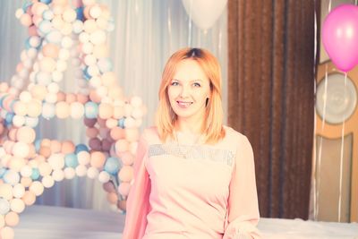 Portrait of smiling young woman at home