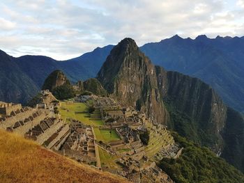 Scenic view of mountains against cloudy sky