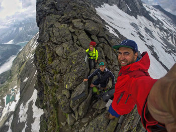 People skiing on snow covered mountain