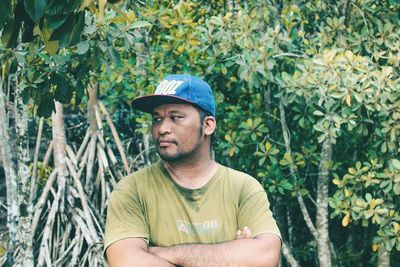 Portrait of young man against plants