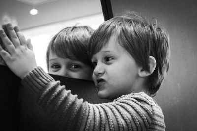 Close-up of cute boy reflecting in mirror