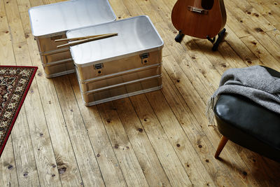 High angle view of metallic containers on hardwood floor