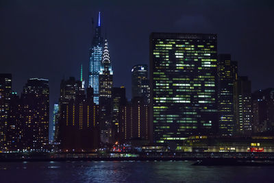 Illuminated buildings against sky at night