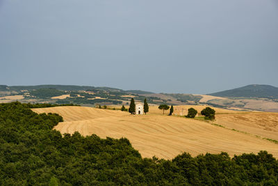 Scenic view of farm landscape against clear sky