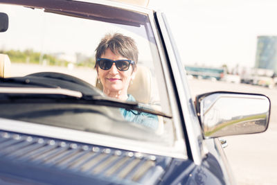 Portrait of smiling woman in car