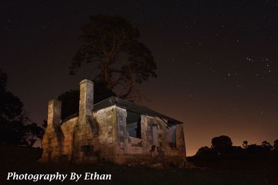 Low angle view of old building against sky at night