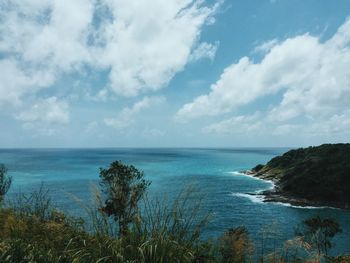 Scenic view of calm sea against cloudy sky