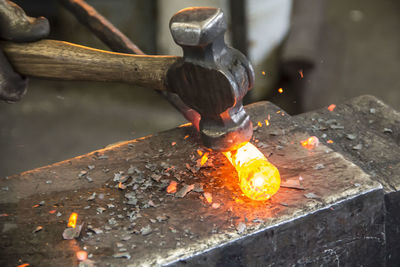Hammer on burning metal