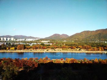 Scenic view of lake against clear blue sky