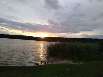 Scenic view of lake against sky during sunset