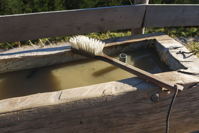 Washing brush lying on a wooden tub.