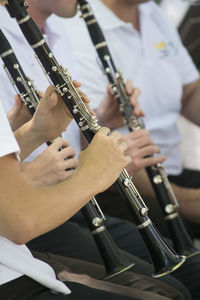 Midsection of people playing flute