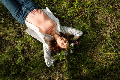 Low section of woman standing on grassy field