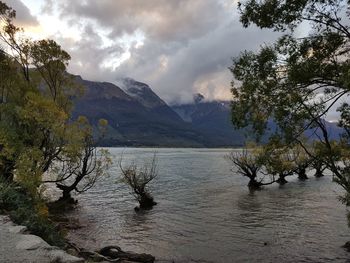 Scenic view of lake and mountains against sky