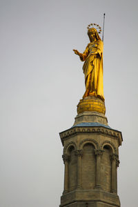 Low angle view of statue of temple against sky