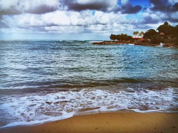 Scenic view of sea against cloudy sky