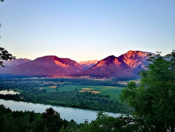 Scenic view of lake and mountains against clear sky
