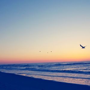 Scenic view of sea against clear sky during sunset