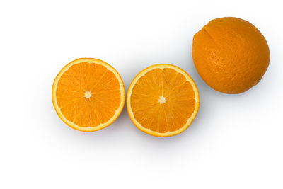 Close-up of orange fruit against white background