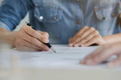 Midsection of man working on table