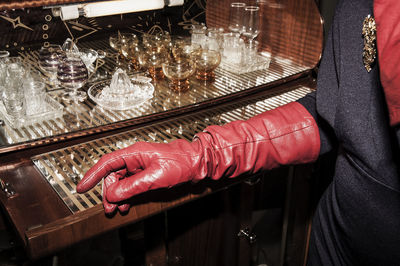 Midsection of woman standing by bar counter