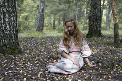 Woman in a folk dress in the forest