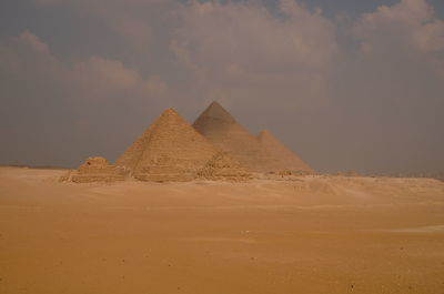 View of desert against cloudy sky