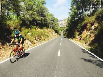 Man riding bicycle on road