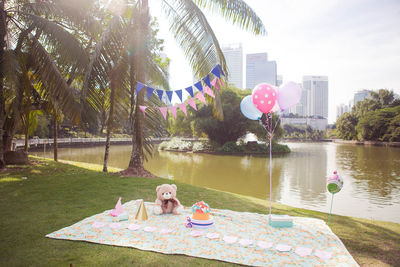 People sitting at swimming pool against sky
