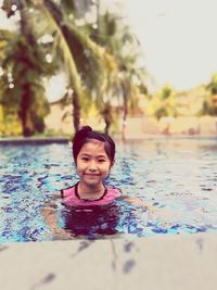 Portrait of smiling girl in swimming pool