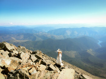 Scenic view of mountains against blue sky