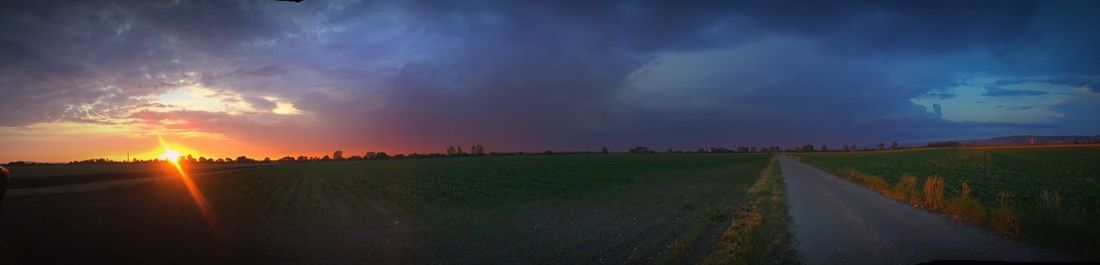 Panoramic view of field against sky during sunset