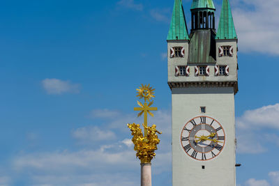 Low angle view of clock tower against sky