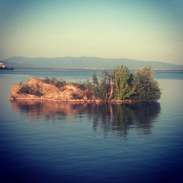 SCENIC VIEW OF LAKE WITH MOUNTAINS IN BACKGROUND