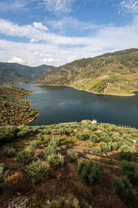 Scenic view of lake and mountains against sky