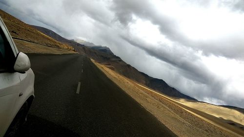 Scenic view of mountain road against sky