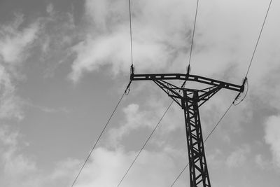 Low angle view of electricity pylon against sky