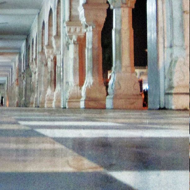 architecture, built structure, architectural column, famous place, travel, men, travel destinations, history, column, building exterior, indoors, tourism, walking, international landmark, the way forward, person, colonnade, corridor, lifestyles