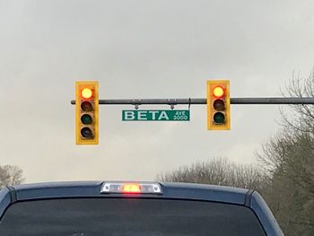 Road sign against sky