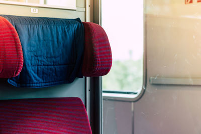 Close-up of red seats in bus