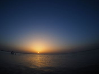 Scenic view of sea against clear sky during sunset