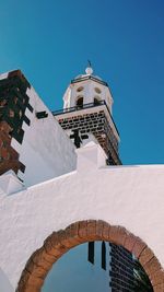 Low angle view of church against clear blue sky