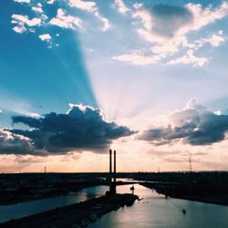 Scenic view of river against cloudy sky