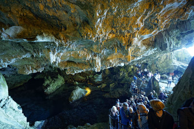 Group of people on rock in cave