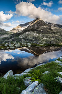 Scenic view of lake and mountains against sky