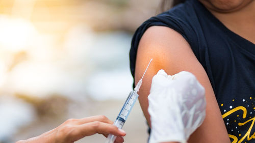 Close-up of doctor giving injection to patient